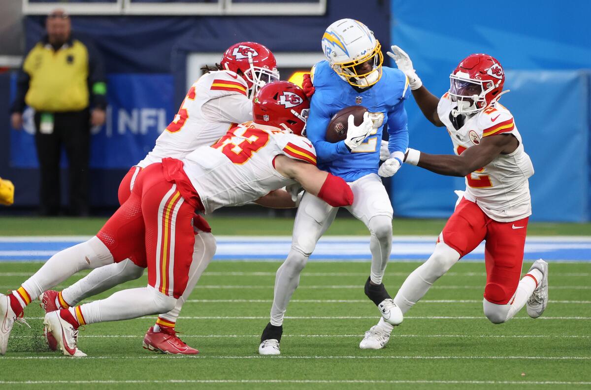 Chargers wide receiver Derius Davis is surrounded by Chiefs defenders after making a catch. 