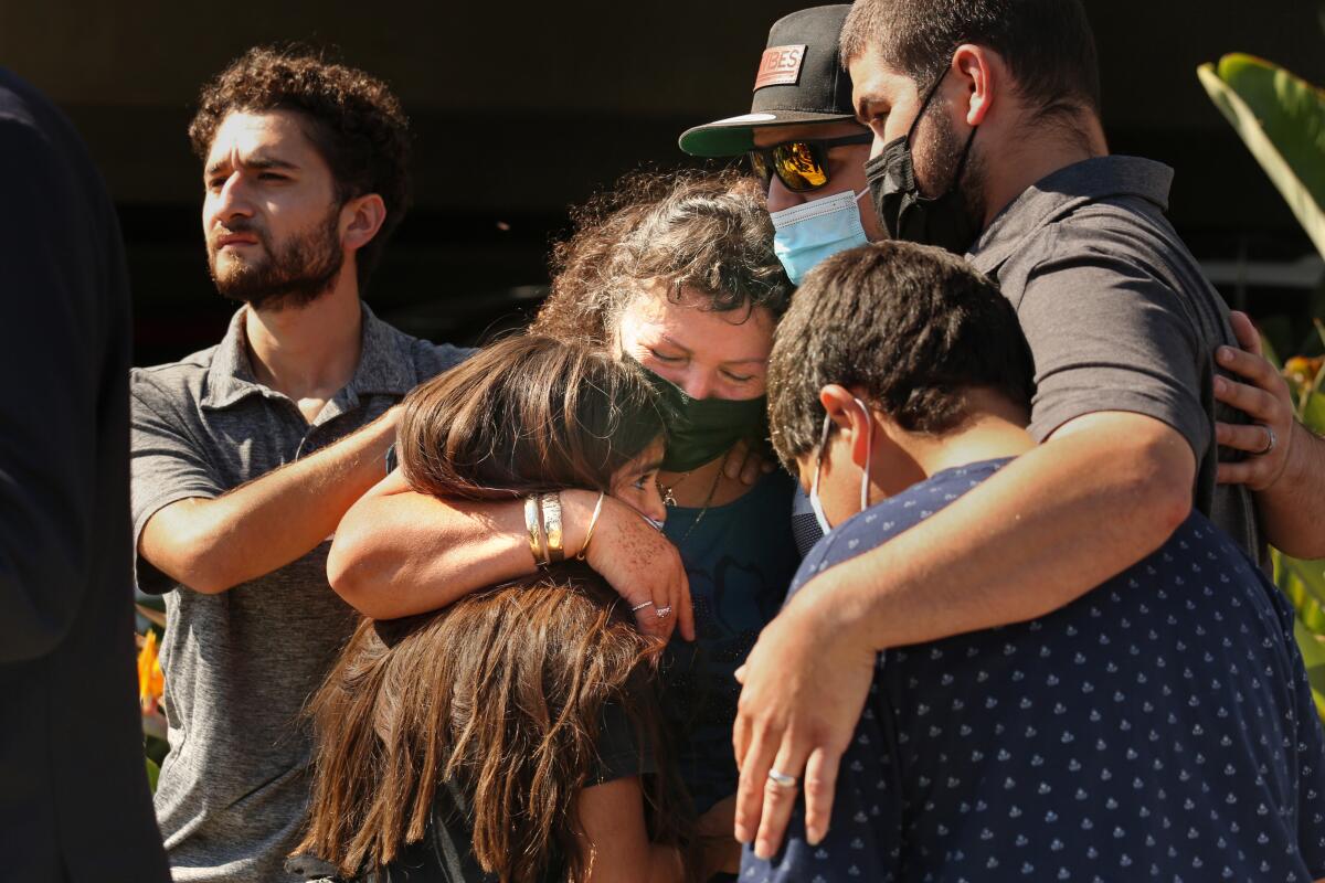 Manuela Sahagun, mother of Mona Rodriguez, center, hugs family members.