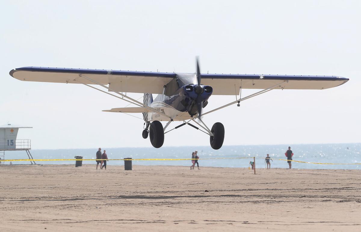 An aircraft makes a landing on the sand during the Pacific Airshow press conference.