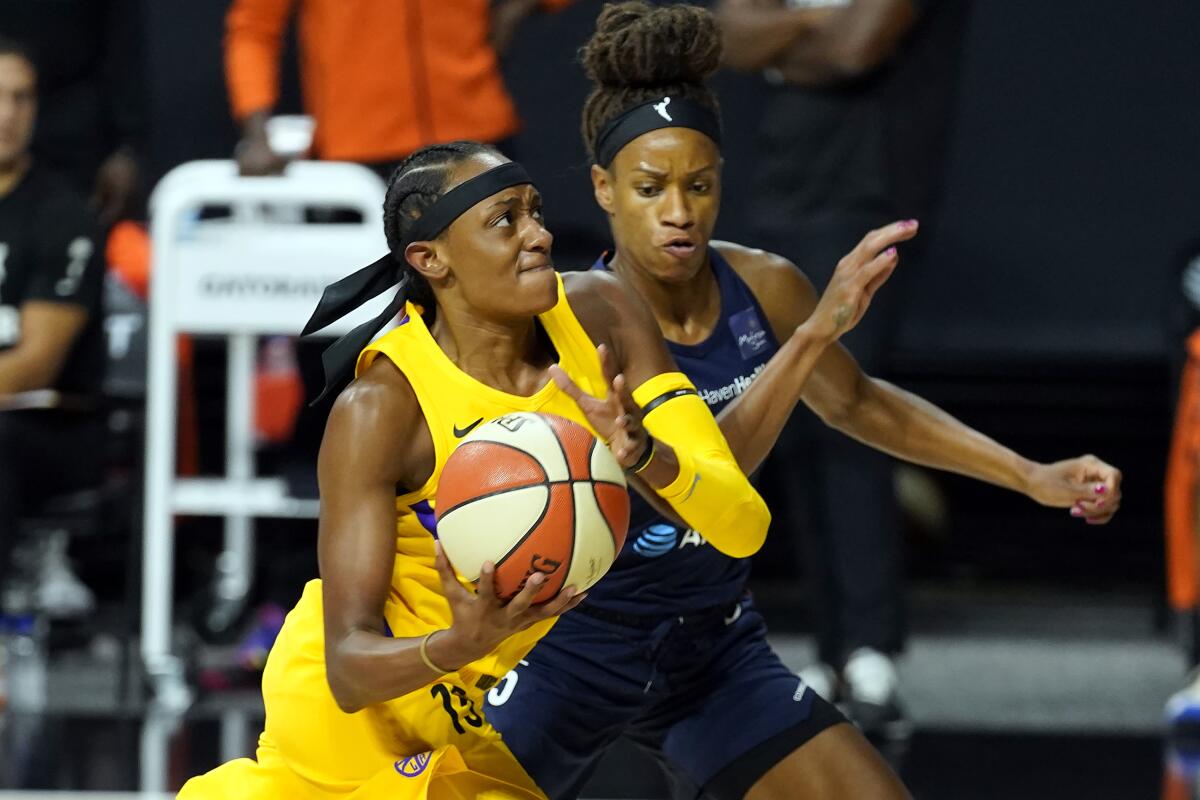 Sparks guard Brittney Sykes drives against Connecticut Sun guard Jasmine Thomas.