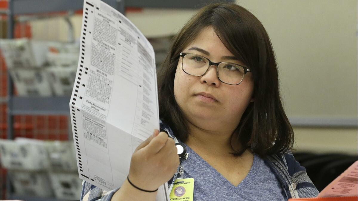 A mail-in ballot in Sacramento County is inspected before it is counted on June 10, 2016. In that election's U.S. Senate primary, close to a quarter-million ballots weren't counted when voters selected more than one candidate.