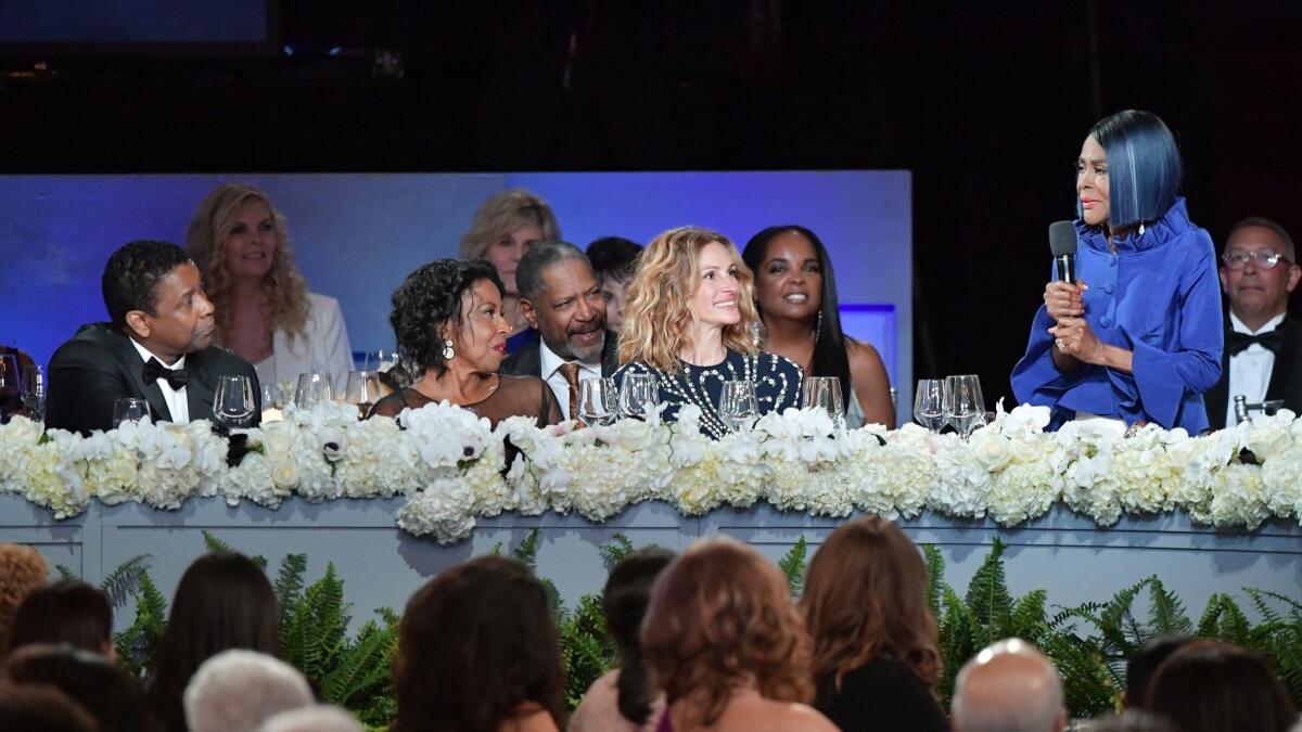 Cicely Tyson, right, speaks to Denzel Washington, his wife Pauletta Washington and Julia Roberts.
