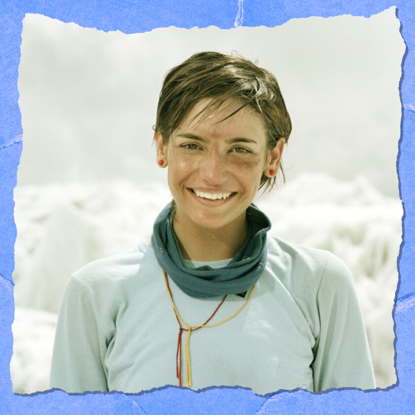 Closeup of a smiling woman against a backdrop of snow.