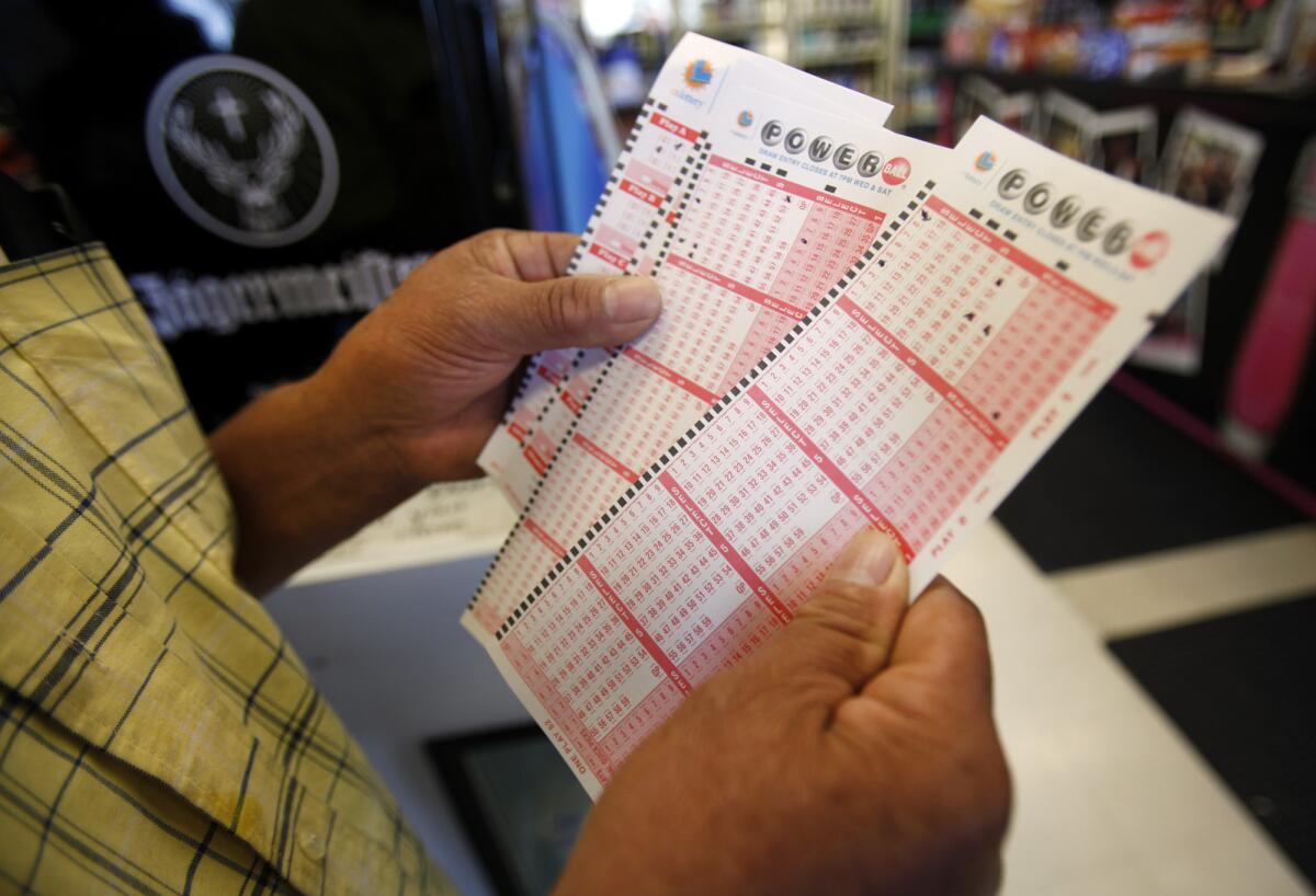 In this file photo from 2013, Rafael Moreno picks his lucky numbers to play the Powerball.