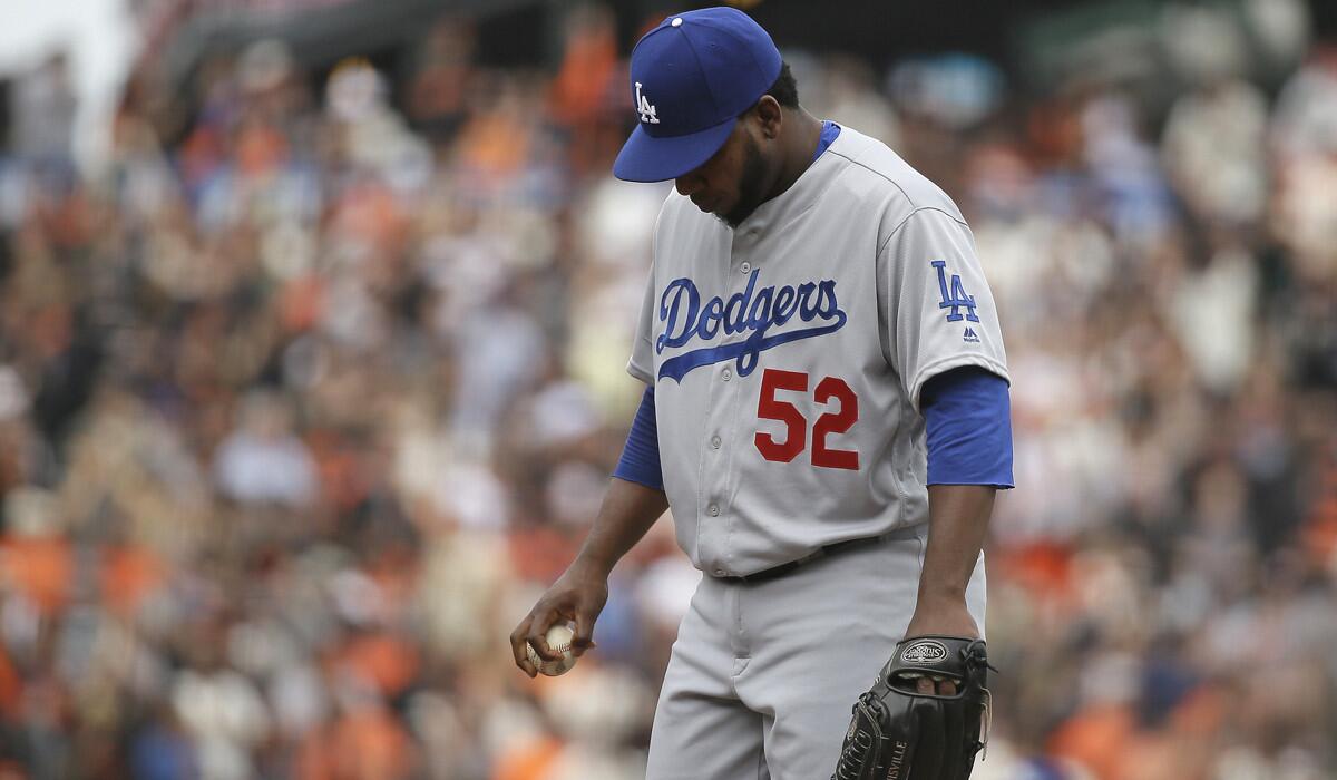 Los Angeles Dodgers relief pitcher Pedro Baez stands on the mound after giving up a grand slam to San Francisco Giants' Hunter Pence in the eighth inning on April 7.