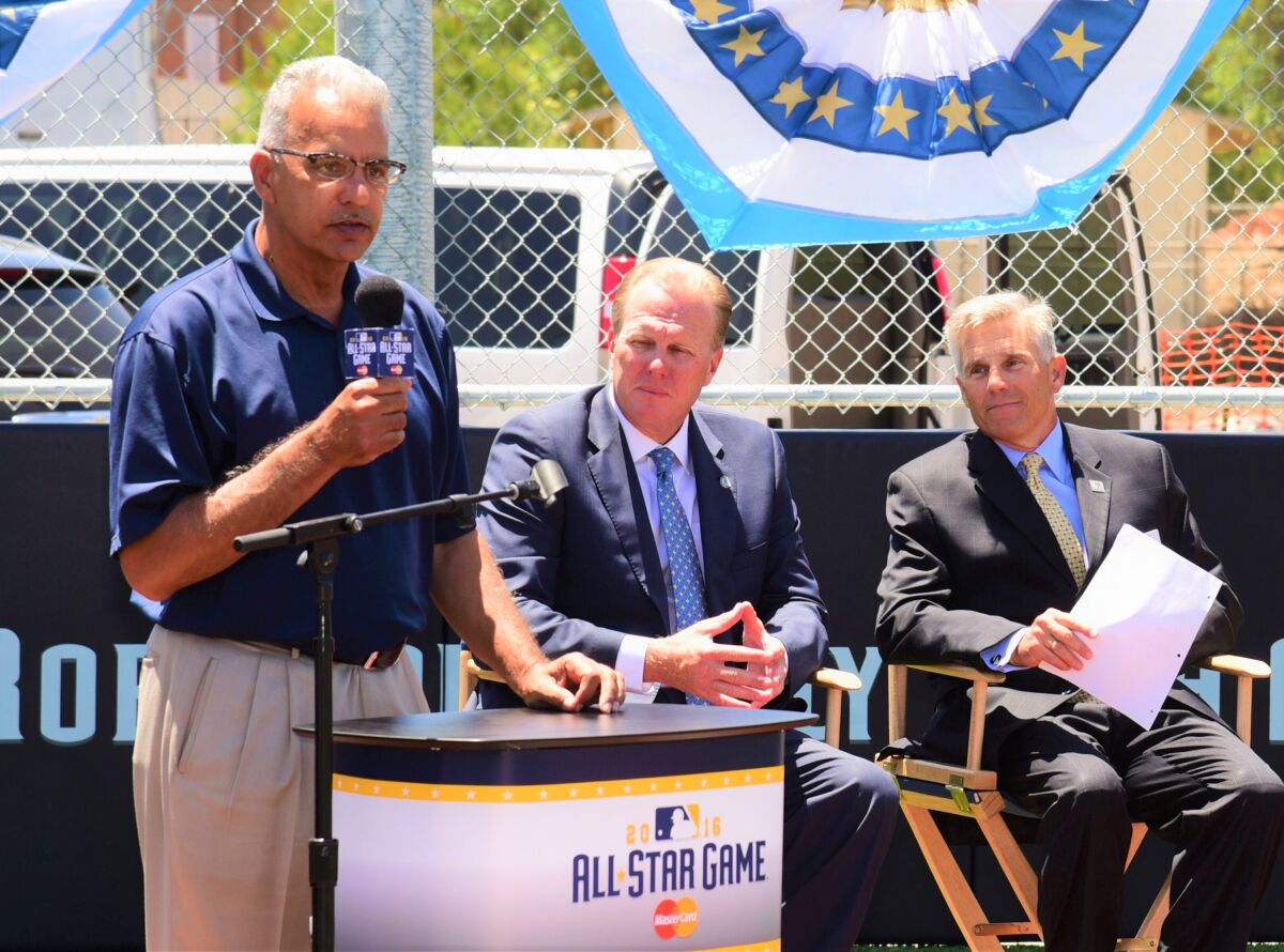 Michael Brunker takes the mike at the ribbon-cutting ceremony for the $1.3 million MLB All-Star Sports Complex at the Jackie Robinson Family YMCA. To his right is San Diego Mayor Kevin Faulconer, and county YMCA head Baron Herdelin-Doherty is at the far right.