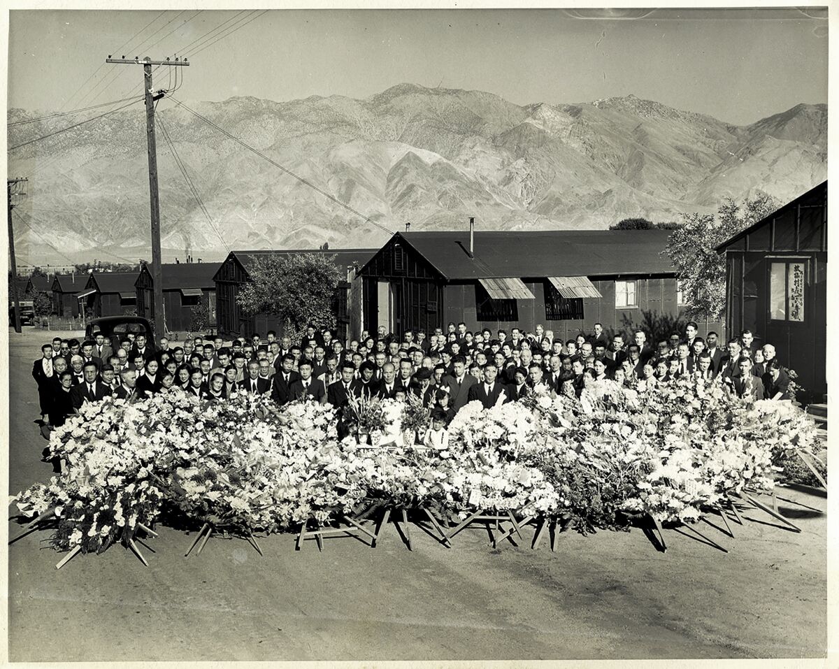 This 1945 photo shows a memorial service for Giichi Matsumura at the internment camp for people of Japanese ancestry in Manzanar, Calif., during World War II. (Toyo Miyatake Studio via AP)