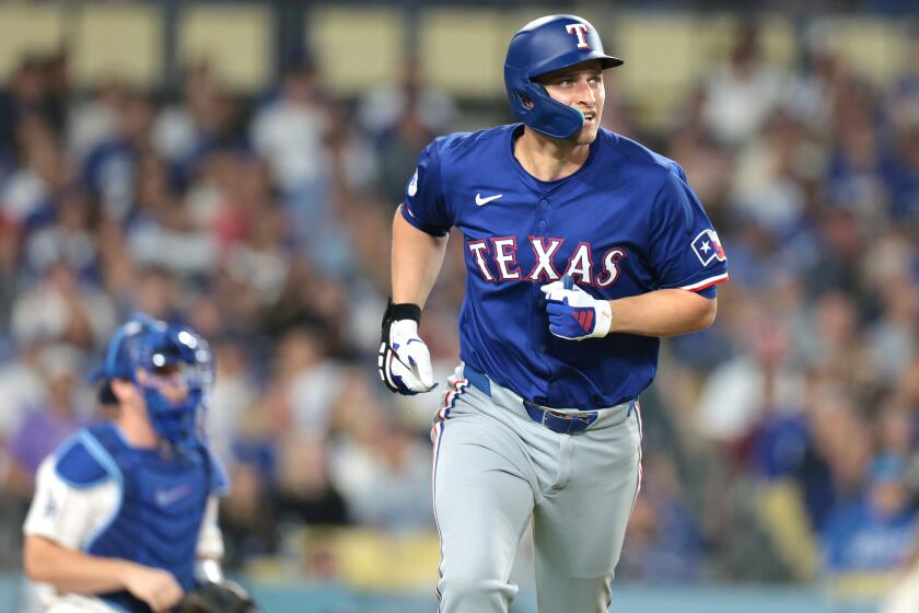 LOS ANGELES CALIFORNIA CALIFORNIA-Rangers Corey Seager hits a there-run home run against the Dodgers in the fifth inning at Dodgers Stadium Wednesday. (Wally Skalij/Los Angeles Times)