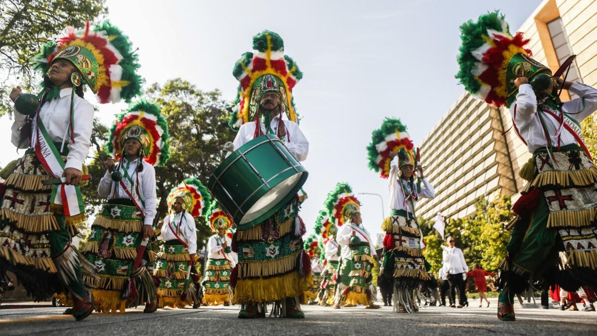Mexican dancers begin the procession to honor Our Lady Queen of Angels to celebrate Los Angeles's 237th birthday.