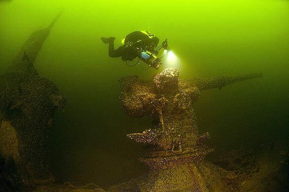 A handout photo shows a diver examining the deck gun of a Soviet submarine that was sunk in 1940 during the Winter War between Finland and the Soviet Union. The wreck was discovered by divers near Finland's Aaland islands.
