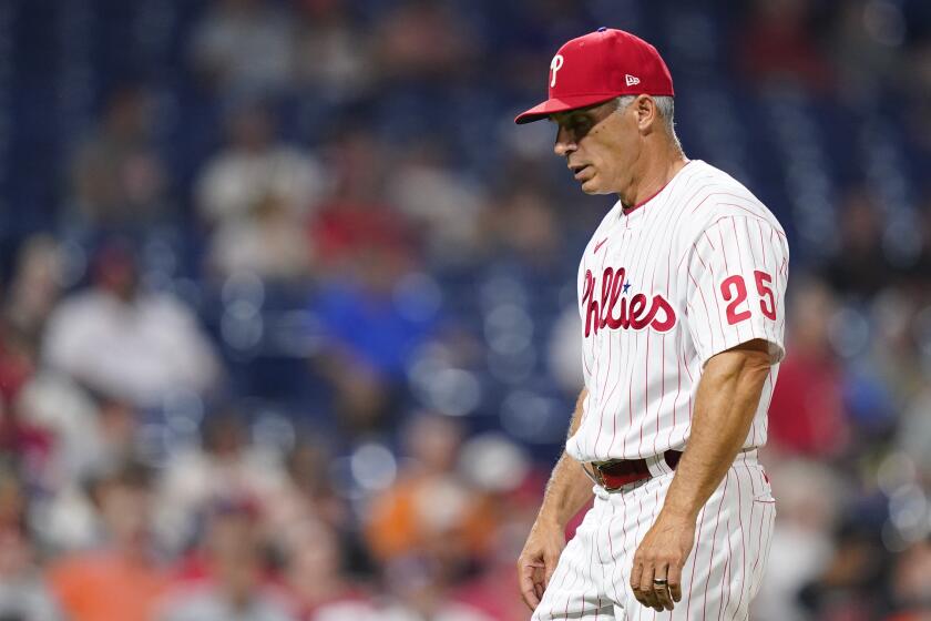 FILE - Philadelphia Phillies' Joe Girardi walks to the dugout during a baseball game, Tuesday, May 31, 2022, in Philadelphia.