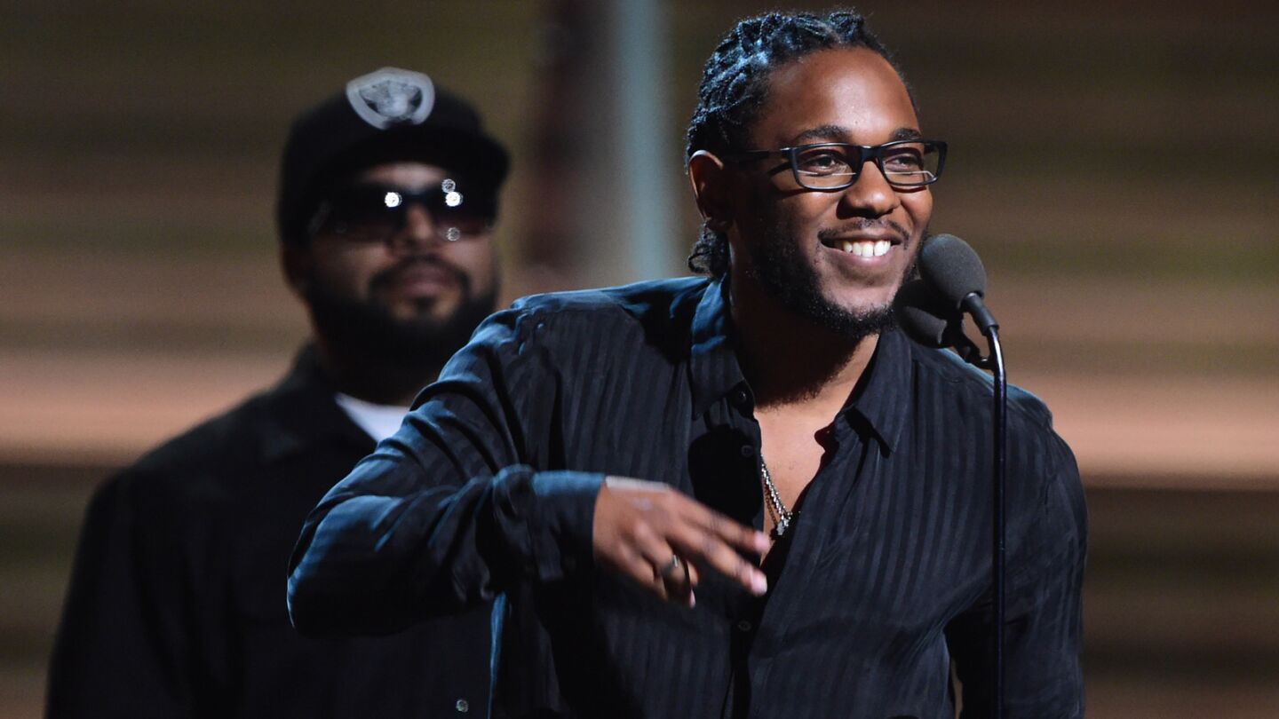 Kendrick Lamar recieves the Grammy for his rap album "To Pimp a Butterfly" as Ice Cube looks on.