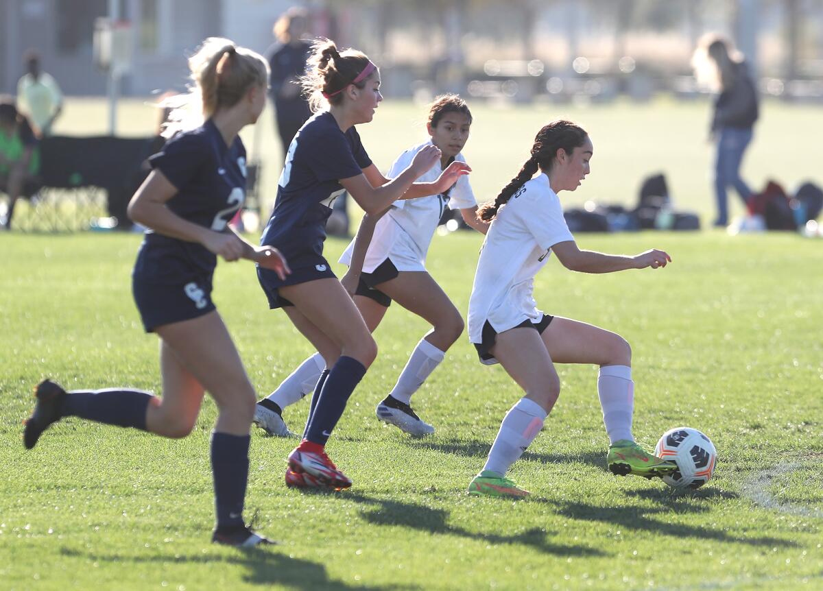 Costa Mesa's Alexys Lopez, far right, outruns the Calvary Chapel defense during an Orange Coast League game on Jan. 27.