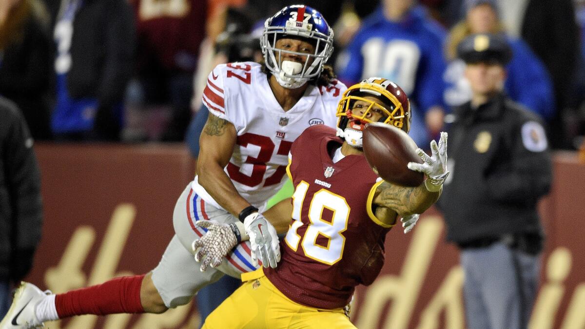Redskins wide receiver Josh Doctson attempts a one-handed catch while defended by Giants defensive back Ross Cockrell during the first half Thursday night.