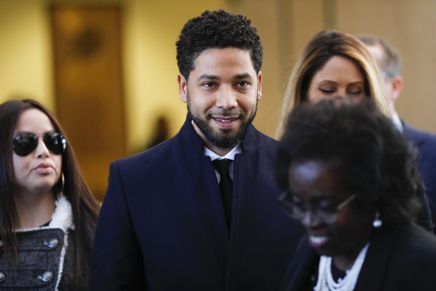 Jussie Smollett cracks a smile as he walks out to speak to the media after all charges against him are dropped at the Leighton Criminal Court Building in Chicago on March 26, 2019.