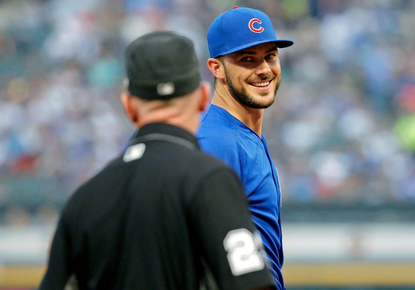 Kris Bryant smiles as he talks with third base umpire Lance Barksdale before the game against the White Sox at Guaranteed Rate Field on July 26, 2017.