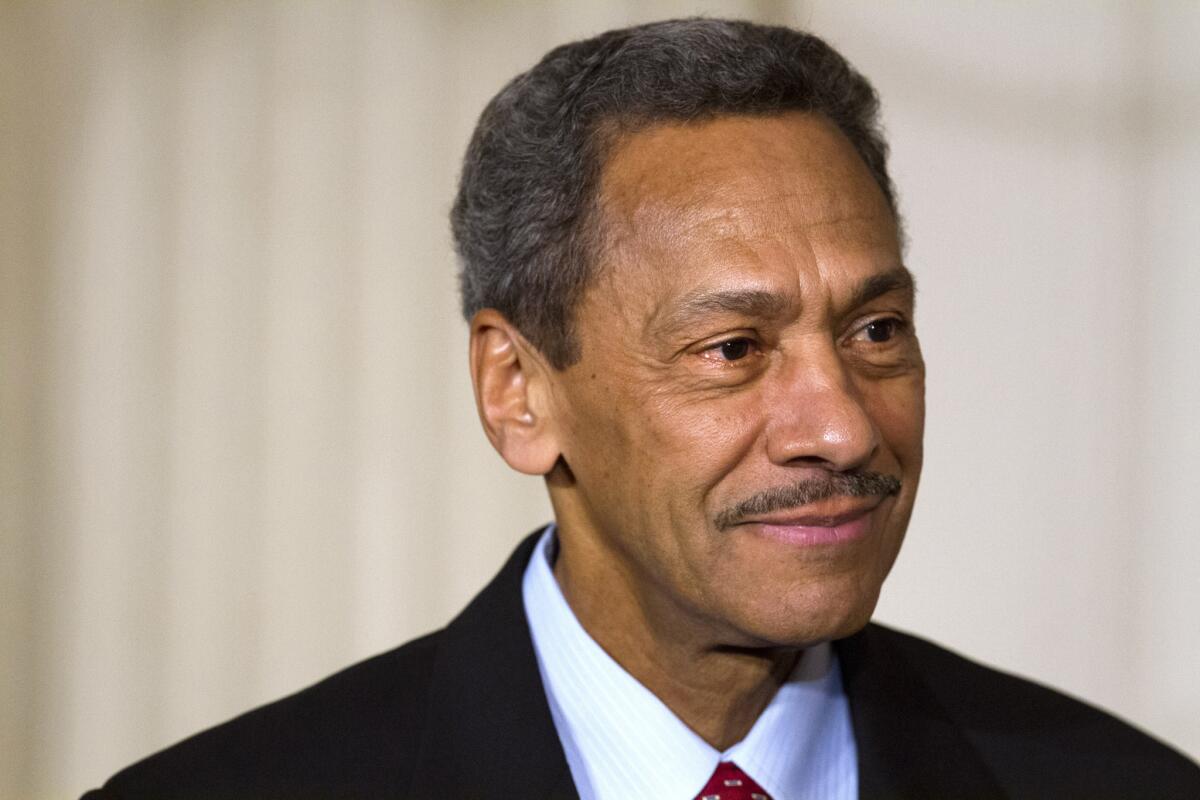 In this May 1, 2013, file photo, Mel Watt waits while President Obama announces his nomination as director of the Federal Housing Finance Agency.