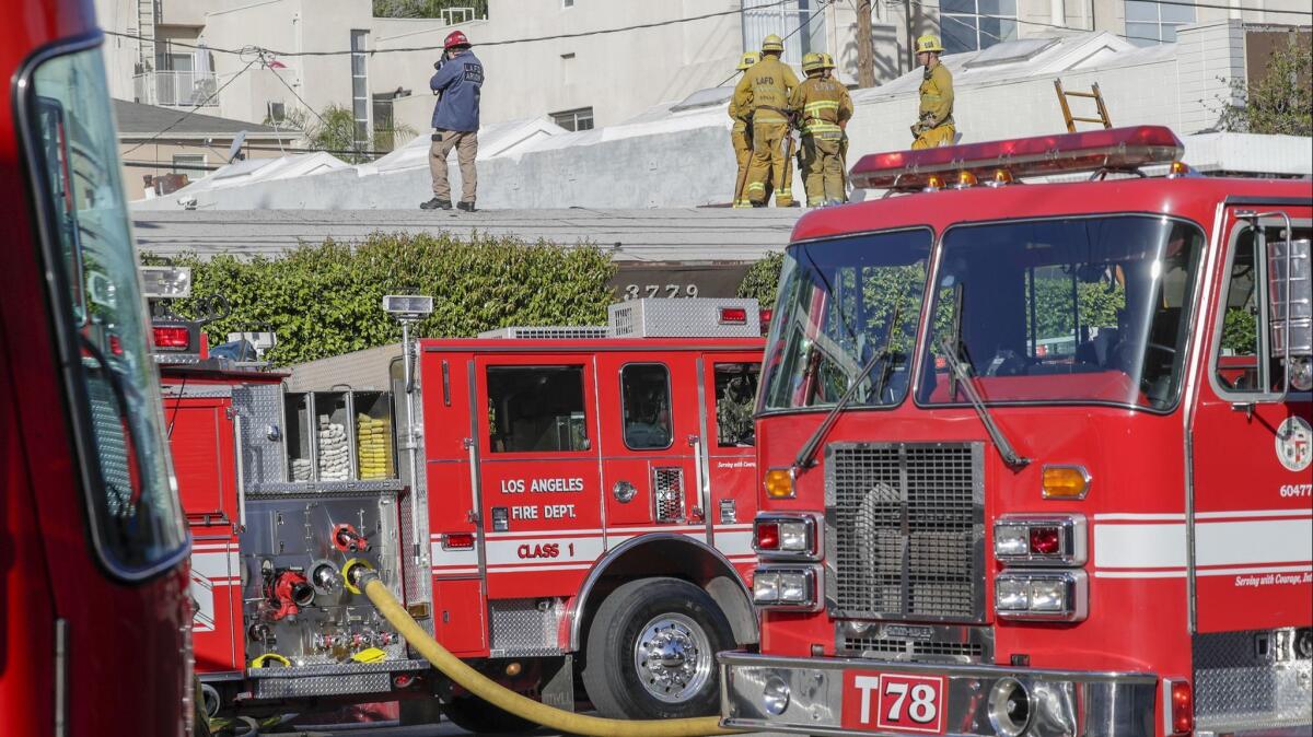 Los Angeles Fire Departments arson investigators at the recording studio fire in which two people lost three lives and two were seriously injured.