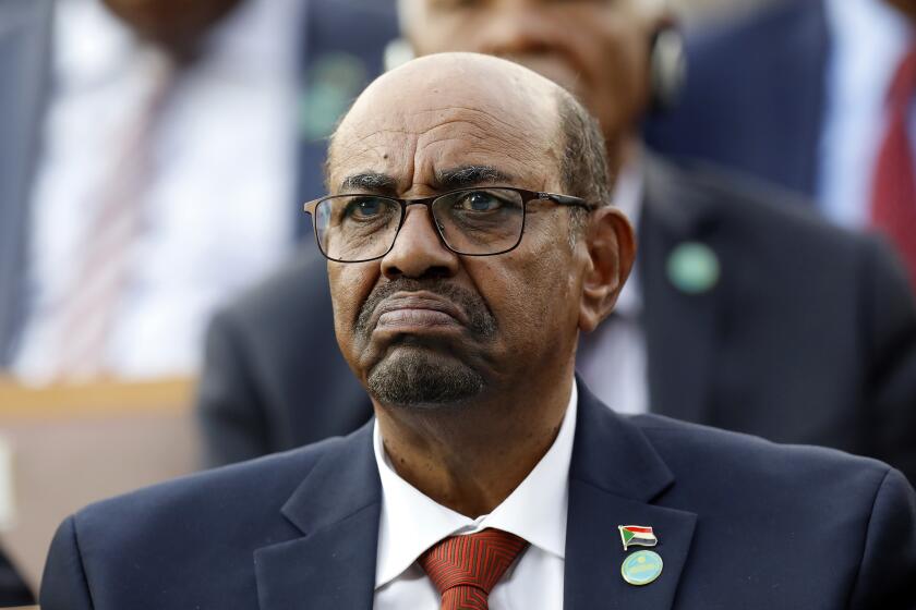 In this July 9, 2018, file photo, Sudan's President Omar al-Bashir attends a ceremony for Turkey's President Recep Tayyip Erdogan, at the Presidential Palace in Ankara, Turkey. On Saturday, Dec. 14, 2019, a Sudan court convicted al-Bashir of money laundering, sentences him to 2 years in rehabilitation facility. (AP Photo/Burhan Ozbilici, File)