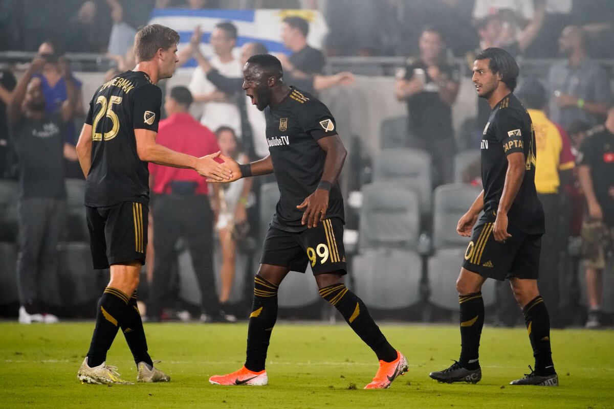 LAFC forward Adama Diomande, center, celebrates with teammates after scoring against the Galaxy on Thursday.