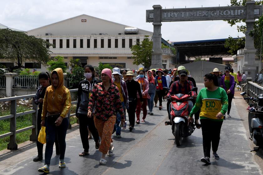 Cambodian workers exit their factory as they take a lunch break in Phnom Penh on March 2, 2020. - Cambodia's multi-billion-dollar garment industry is at risk of chain disruption from the deadly coronavirus, its strongman premier said March 2, as its impacts hammer on Southeast Asia's key industries and bring border trade to a trickle. (Photo by TANG CHHIN Sothy / AFP) (Photo by TANG CHHIN SOTHY/AFP via Getty Images)