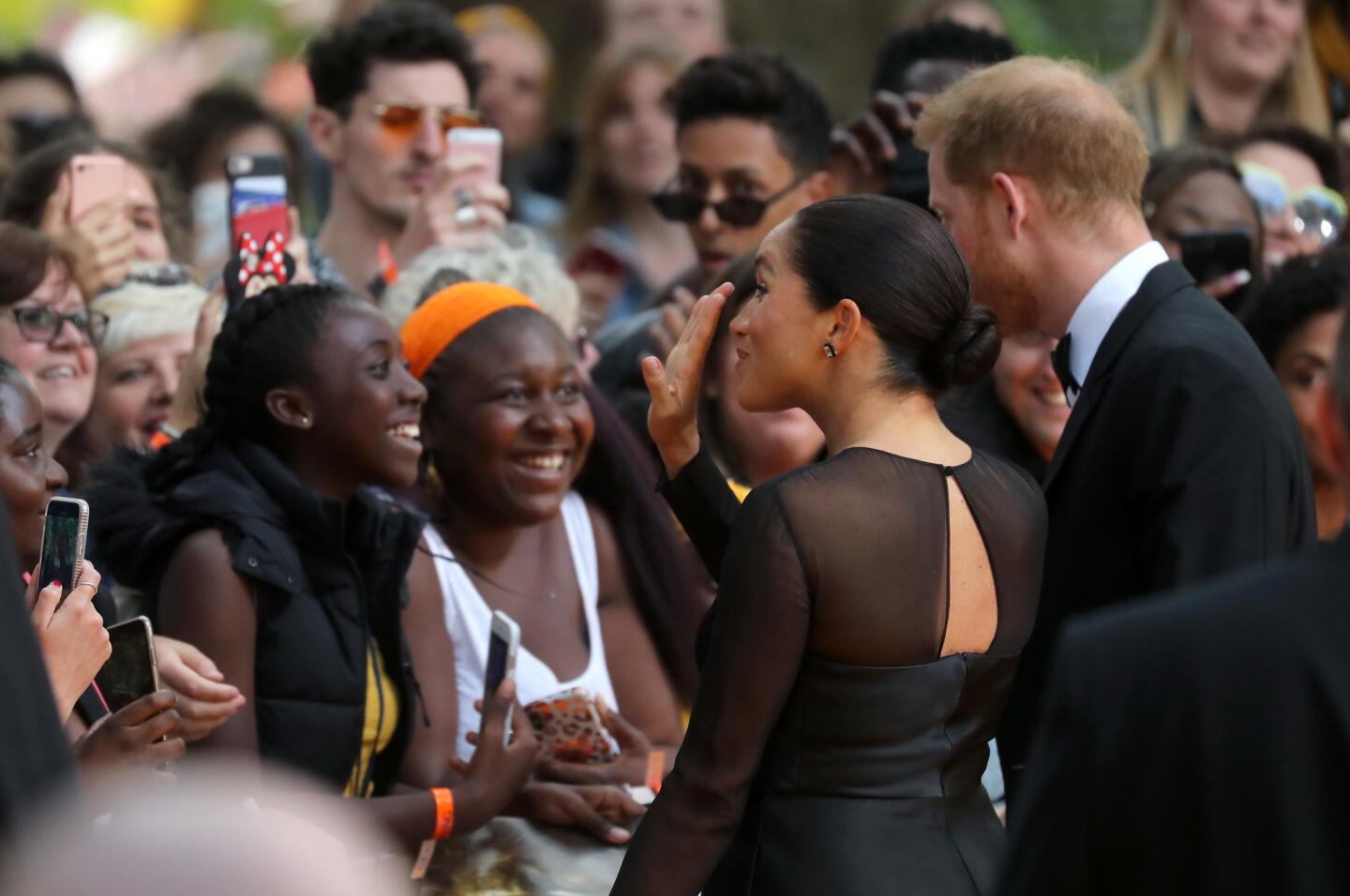 Wellwishers meet Prince Harry, Duke of Sussex and Meghan, Duchess of Sussex as they attend "The Lion King" European premiere at Leicester Square on July 14, 2019 in London, England.