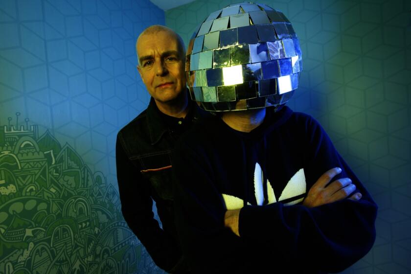 The Pet Shop Boys are Neil Tennant, left, and Chris Lowe, in a mirror ball helmet.