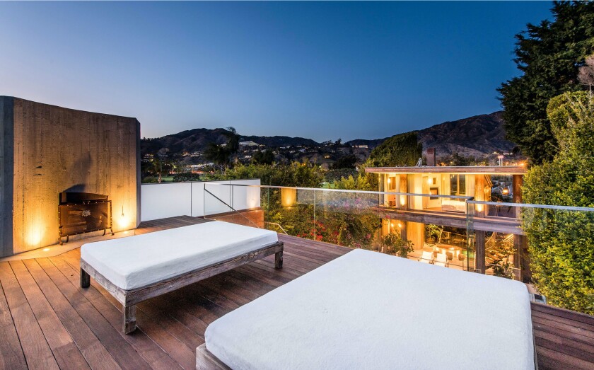 Overlooking Malibu Lagoon, the mini compound holds a 5,500-square-foot main house, one-bedroom guesthouse and sun deck with a swimming pool.