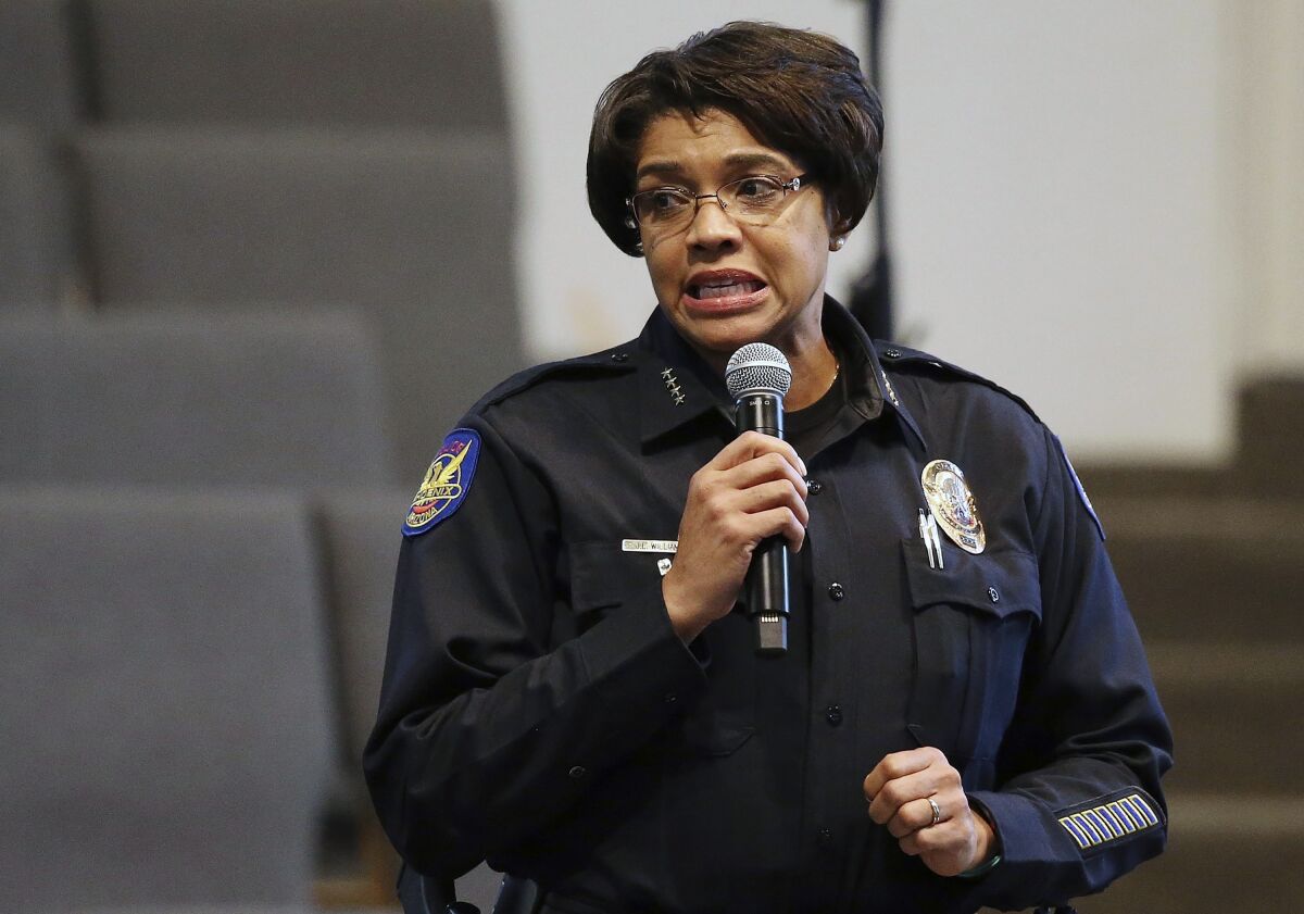 FILE - In this June 18, 2019, file photo, Phoenix Police Chief Jeri Williams addresses the audience at a community meeting in Phoenix. Williams has been given a one-day suspension after lawyers hired by the city issued a report that heavily criticized her agency's role in a now-discredited gang case file against demonstrators at a protest against police brutality. (AP Photo/Ross D. Franklin, File)