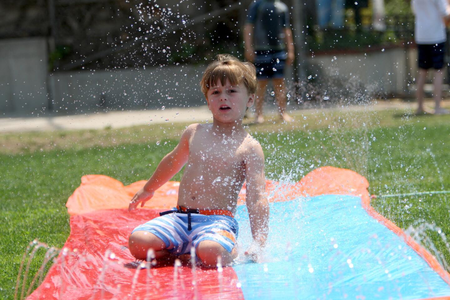 Photo Gallery: Camp Runamuk brings in the water slide to battle the heat wave