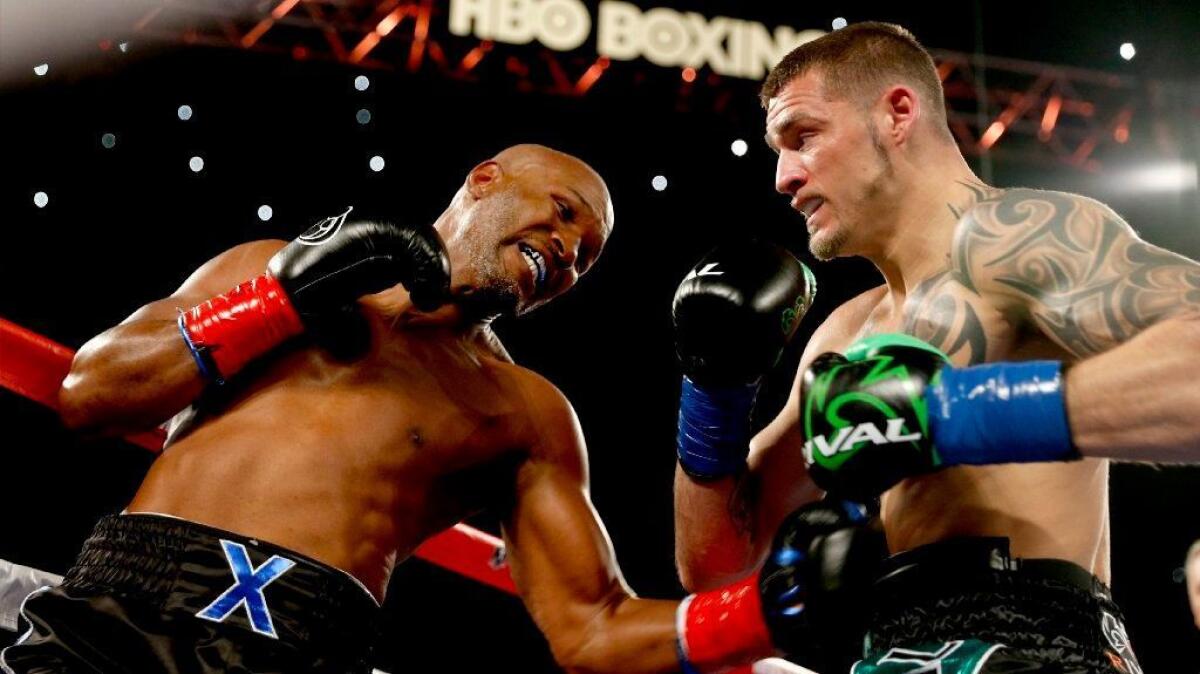 Bernard Hopkins punches Joe Smith Jr. during a fight at the Forum on Dec. 17.