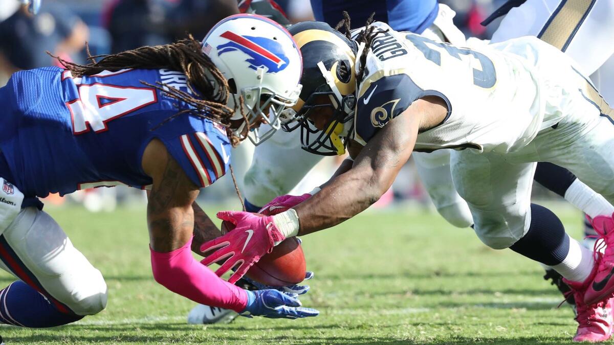 Rams running back Todd Gurley, right, battles Bills cornerback Stephon Gilmore for possession after a second-half fumble. Gurley fumbled twice in the game; he recovered this one but lost the other.