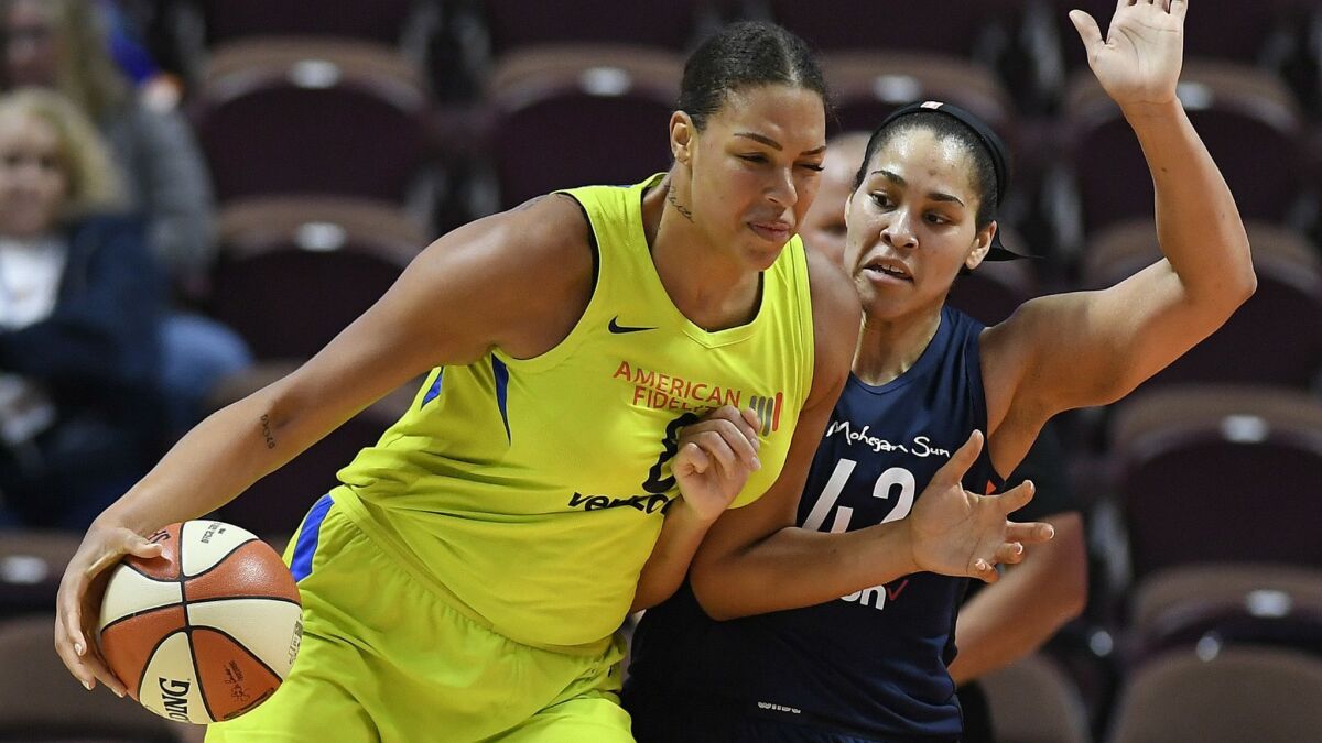 Dallas Wings center Liz Cambage drives against the Connecticut Sun's Brionna Jones during a game in 2018. Cambage was traded to Las Vegas earlier this month.