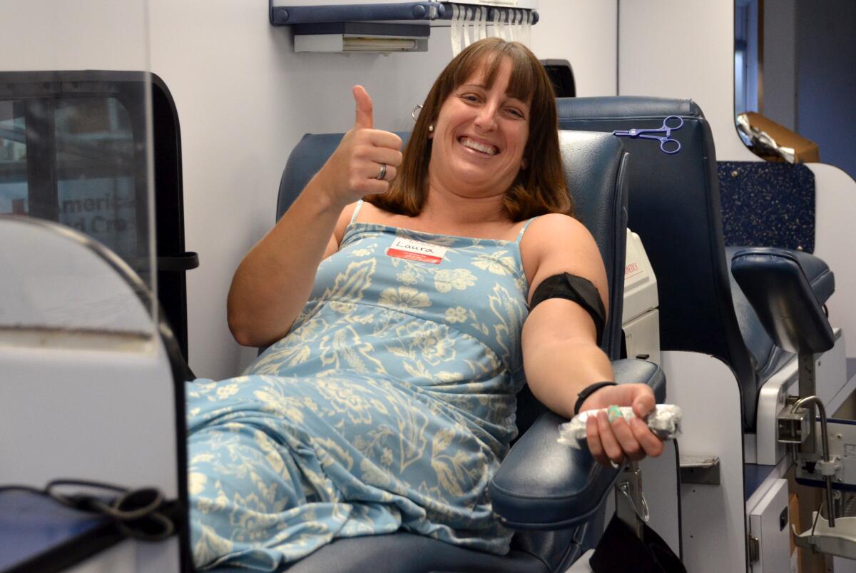Laura Lane gives blood during the Mesa Verde United Methodist Church blood drive.