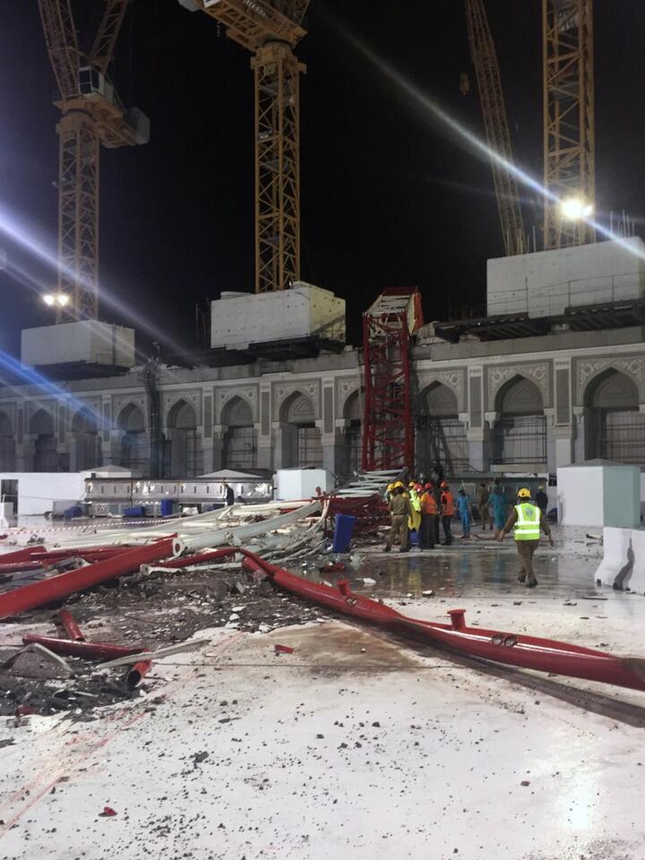 Saudi emergency teams stand next to a crane after it crashed into the Grand Mosque of Mecca Sept. 11, 2015.