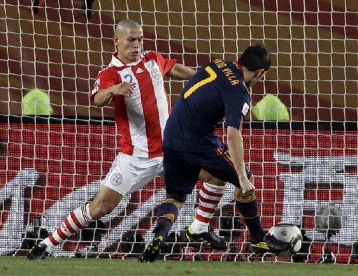 Spain's David Villa, right, scores a goal during the World Cup quarterfinal soccer match between Paraguay and Spain at Ellis Park Stadium in Johannesburg, South Africa, Saturday, July 3, 2010. (AP Photo/Ivan Sekretarev)