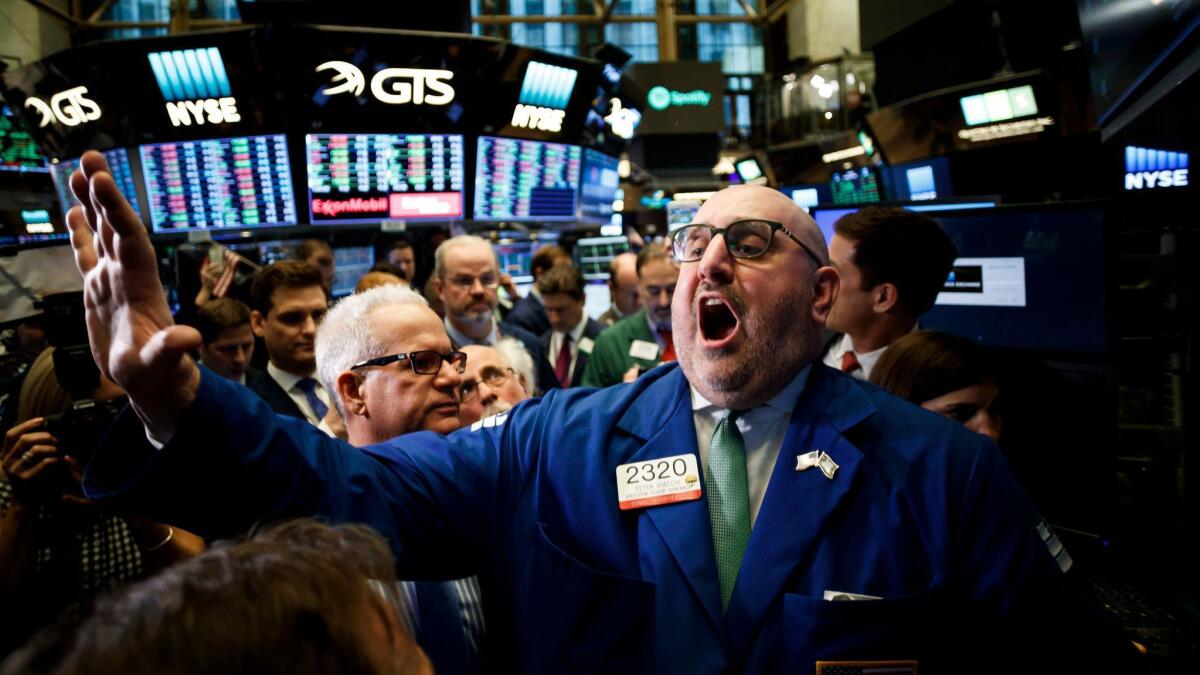 Specialist Peter Giacchi announces the start of trading of shares of Spotify at the New York Stock Exchange on Tuesday.