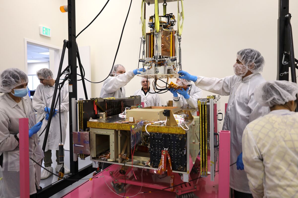 Engineers lower the DOLCE portion of the Space Solar Power Demonstrator onto the Vigoride spacecraft built by Momentus.