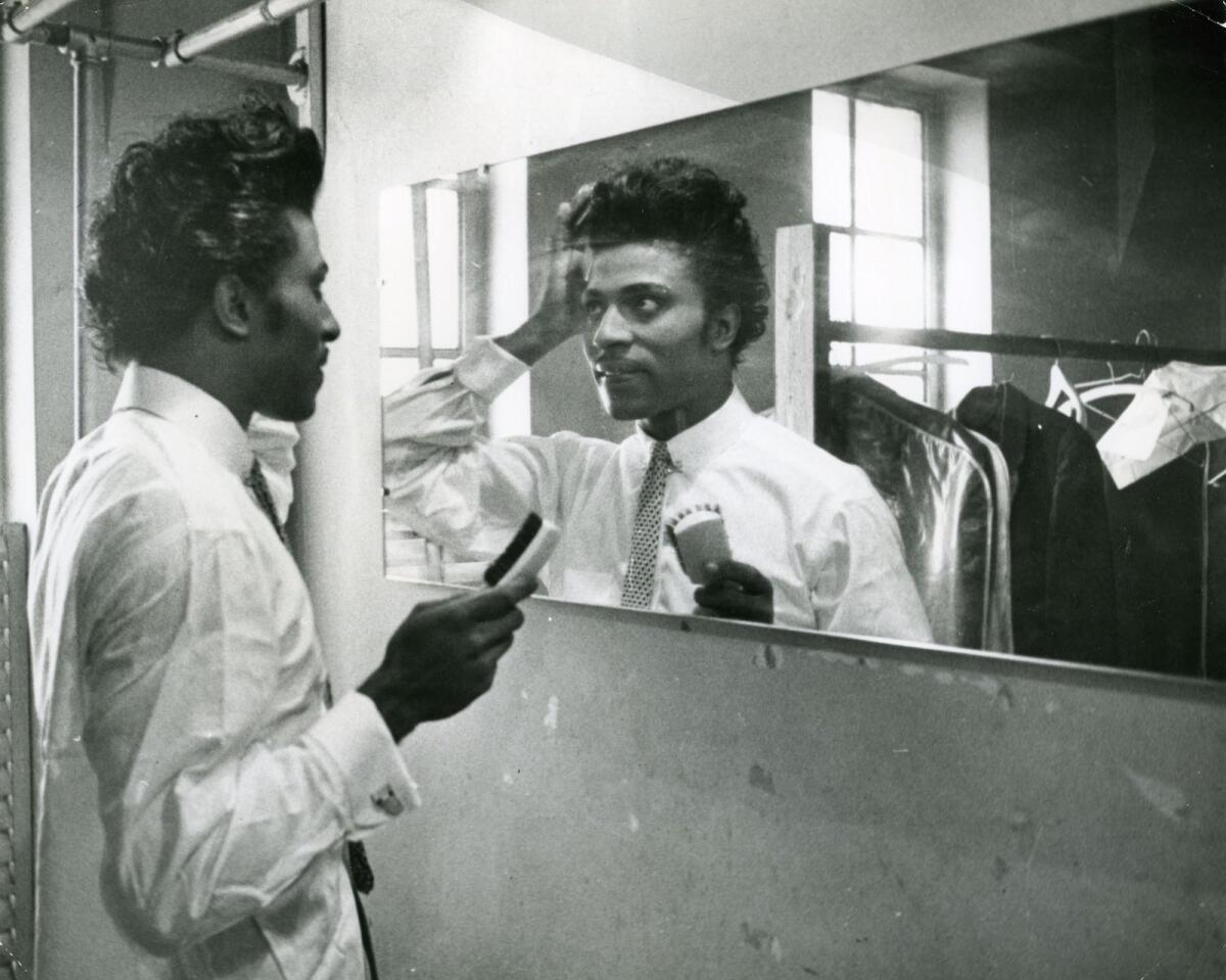Little Richard looks at himself in a mirror