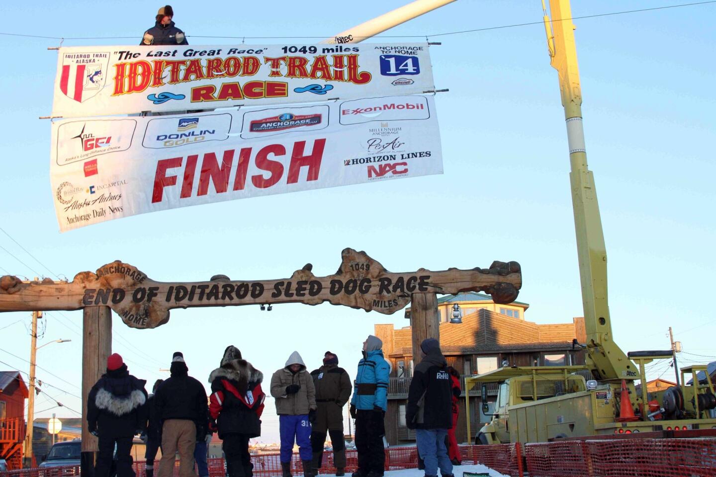 An Iditarod banner is raised above the finish line in Nome, Alaska -- nearly 1,000 miles from the race's start.