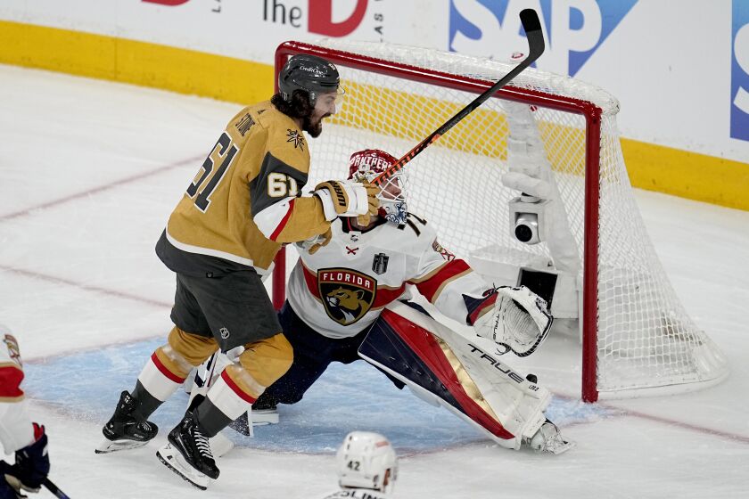 Vegas Golden Knights right wing Mark Stone (61) celebrates a goal by teammate Jonathan Marchessault as Florida Panthers goaltender Sergei Bobrovsky (72) can't make the stop during the first period of Game 2 of the NHL hockey Stanley Cup Finals, Monday, June 5, 2023, in Las Vegas. (AP Photo/Abbie Parr)