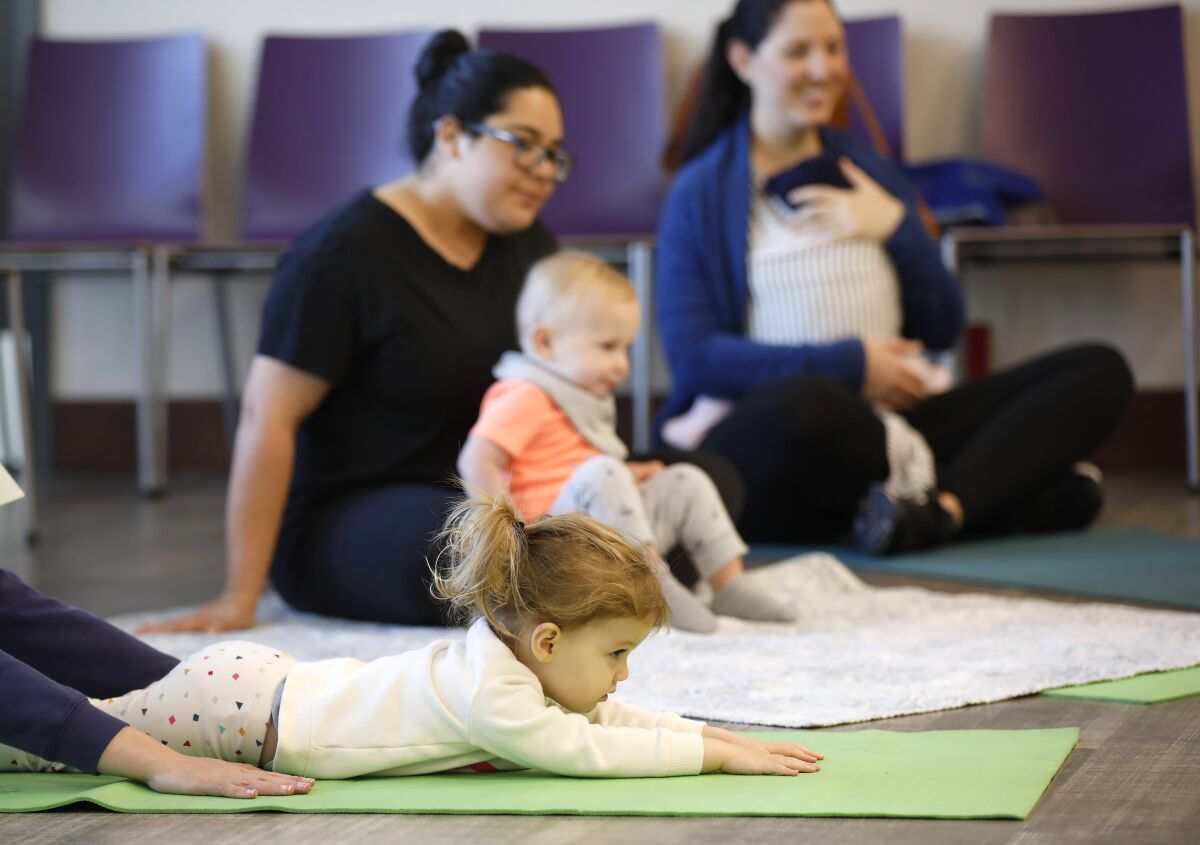 Sylvie Olguin does yoga during Storytime Yoga at the The Mission Hills-Hillcrest/Harley & Bessie Knox Library.
