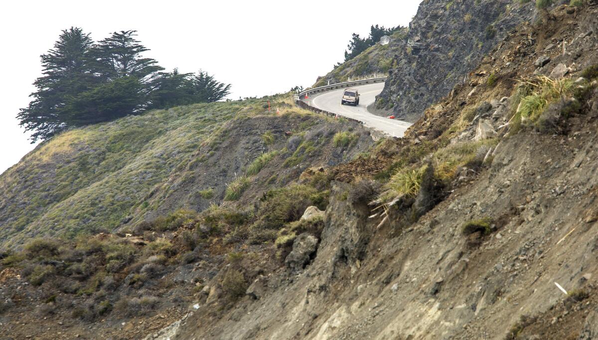 A southbound motorist turns around after hitting a dead end on Highway 1, where a massive landslide cut off the road north of Ragged Point in Monterey County. (Brian van der Brug / Los Angeles Times)