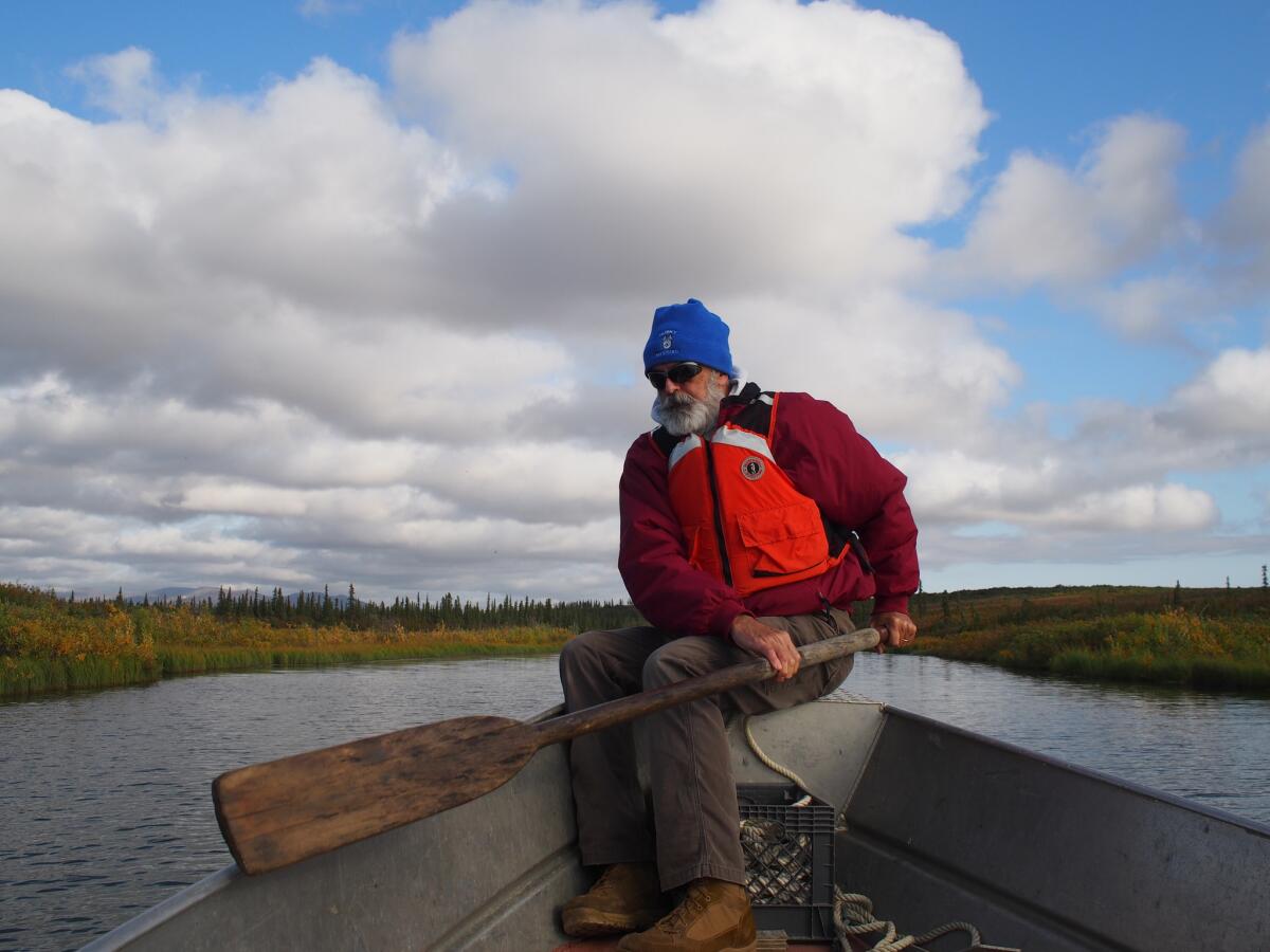 Jay Denton rows along a creek off the Noatak River in Kotzebue, Alaska.