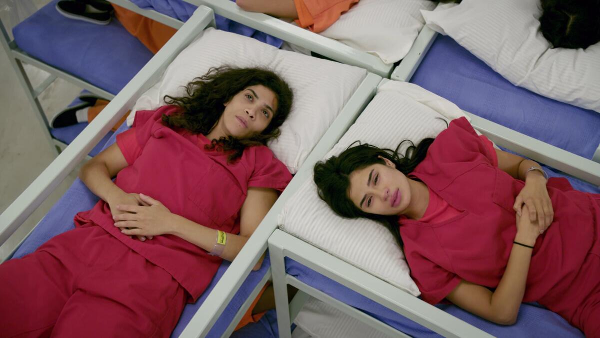 Blanca Flores (Laura Gomez, left) and Maritza Ramos (Diane Guerrero) at an ICE detention center on "Orange Is the New Black."