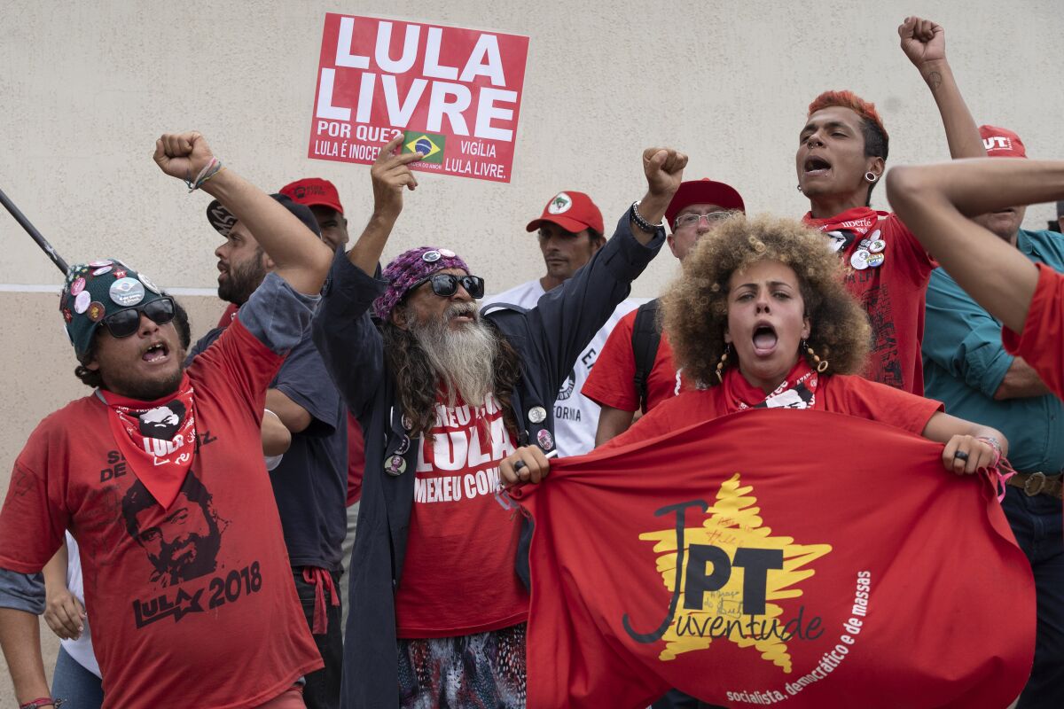 Supporters of former President Luiz Inacio Lula da Silva of Brazil gather Nov. 8 and shout "Free Lula" outside the Federal Police headquarters in Curitiba where Lula is imprisoned.