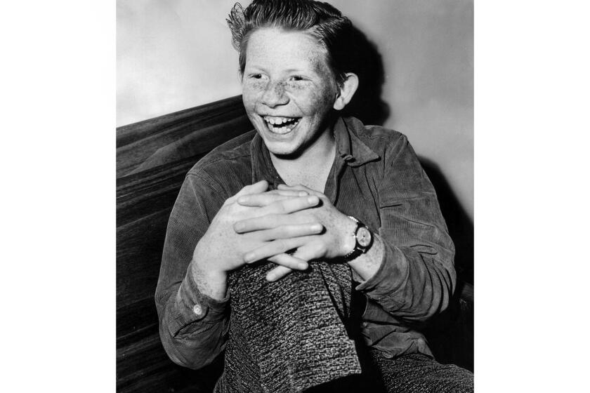 Feb. 10, 1953: Jimmy Boyd, 14, sits in a courthouse for a hearing with a judge to change his professional contracts following the success of his 1952 hit song, "I Saw Mommy Kissing Santa Claus."