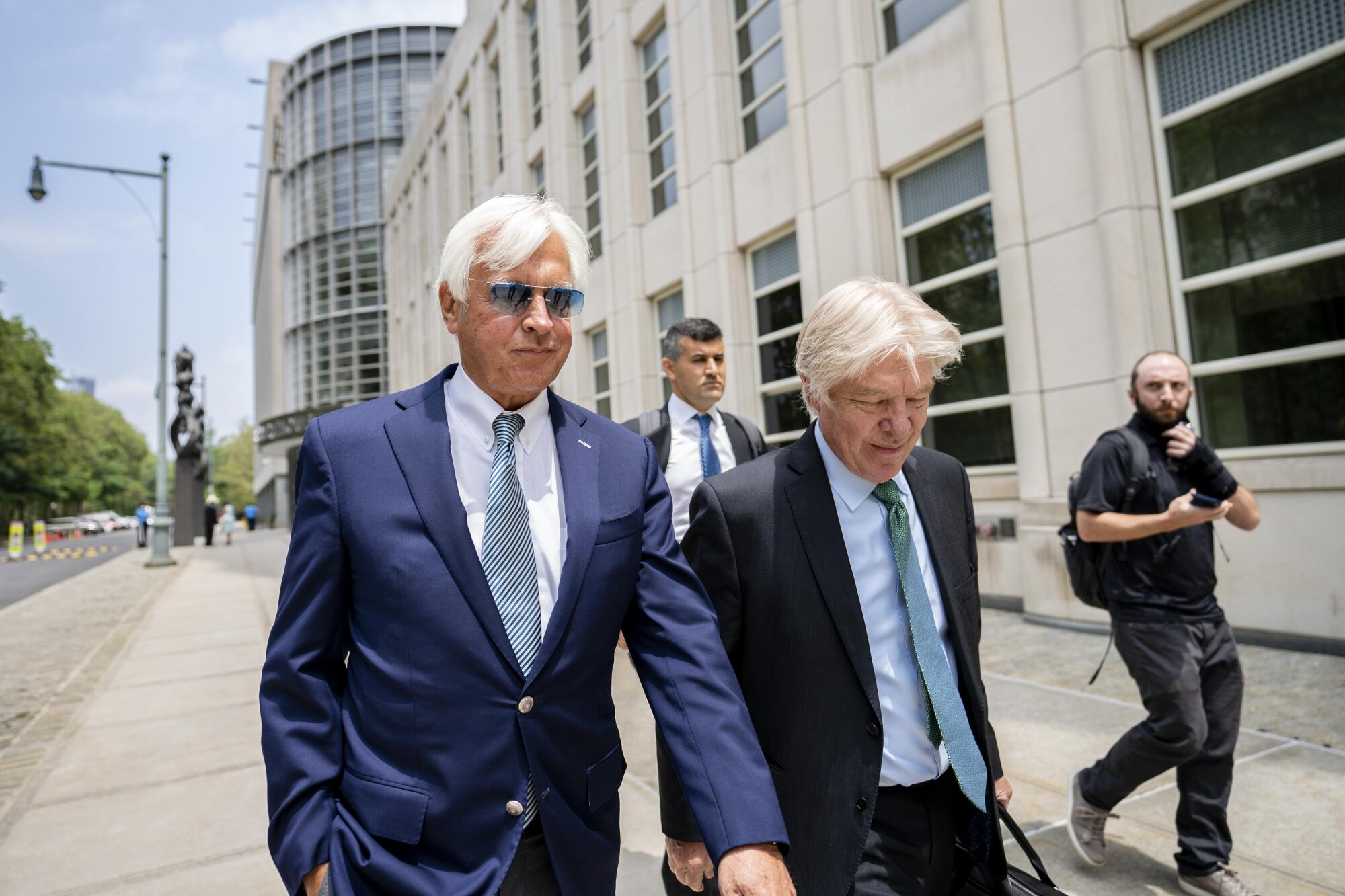 Horse trainer Bob Baffert, left, leaves federal court in Brooklyn on July 12.