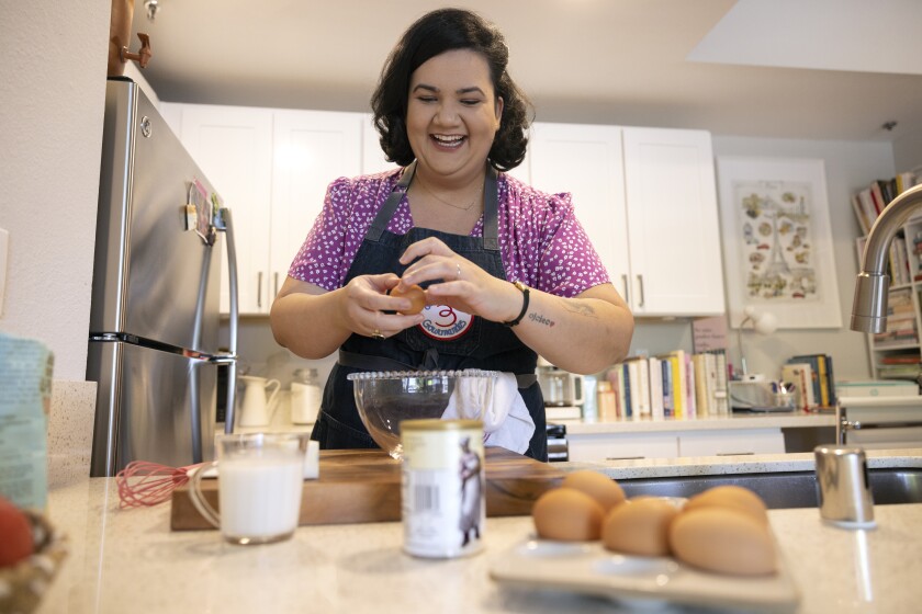 Oceanside resident Jaine Mackievicz-Cenci makes an olive oil and vanilla cake in her apartment in Oceanside on May 18.