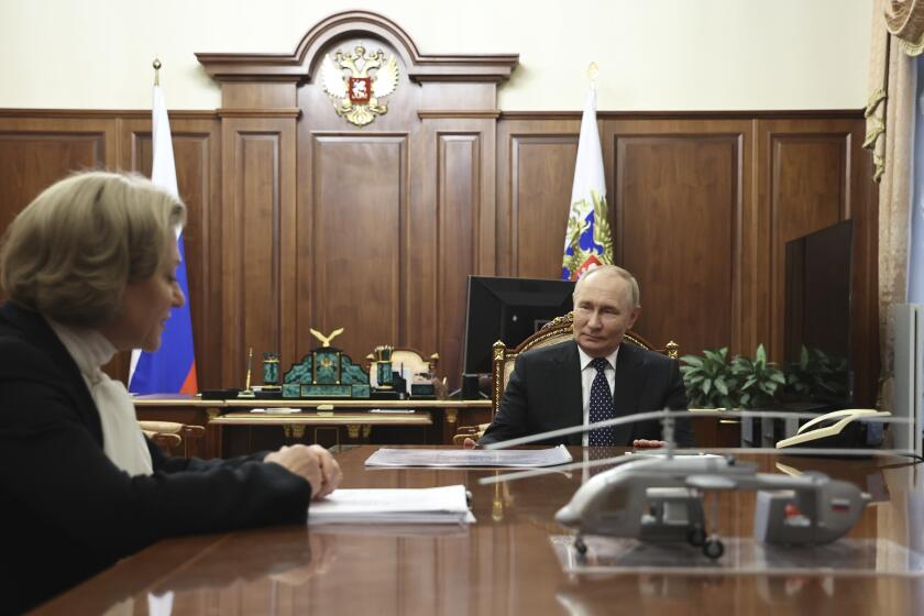 Russian President Vladimir Putin, right, speaks with Anna Popova, the Head of the Federal Service for the Oversight of Consumer Protection and Welfare, during their meeting at the Kremlin in Moscow, Russia, Monday, Sept. 16, 2024. (Alexander Kazakov, Sputnik, Kremlin Pool Photo via AP)